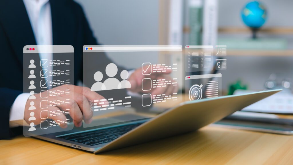 Person using laptop with floating digital icons.