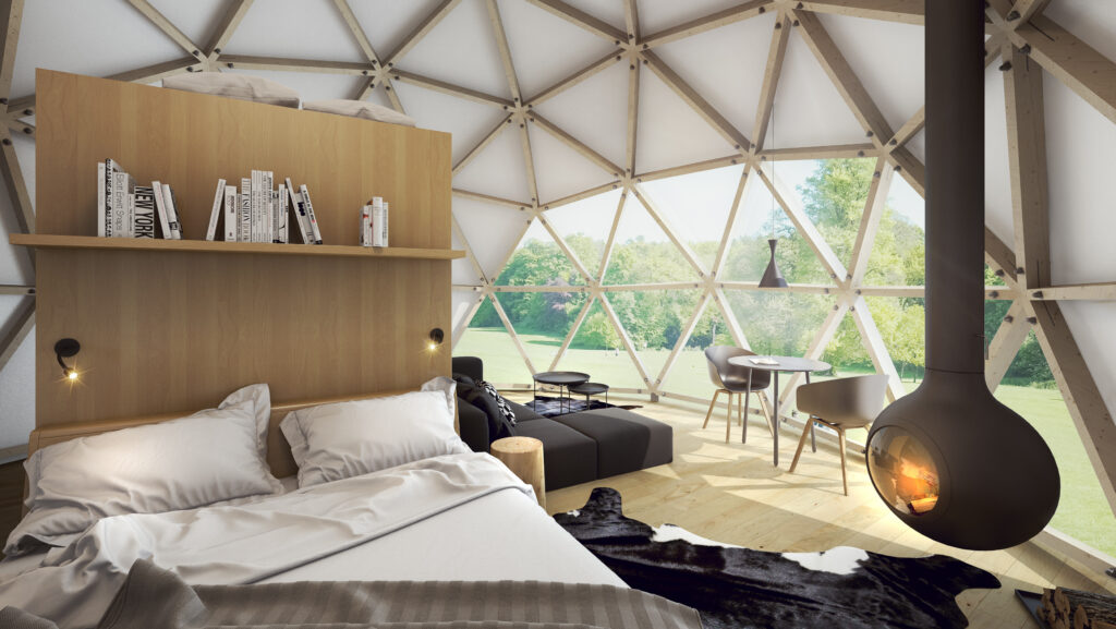 Modern geodesic dome interior with bed and fireplace.