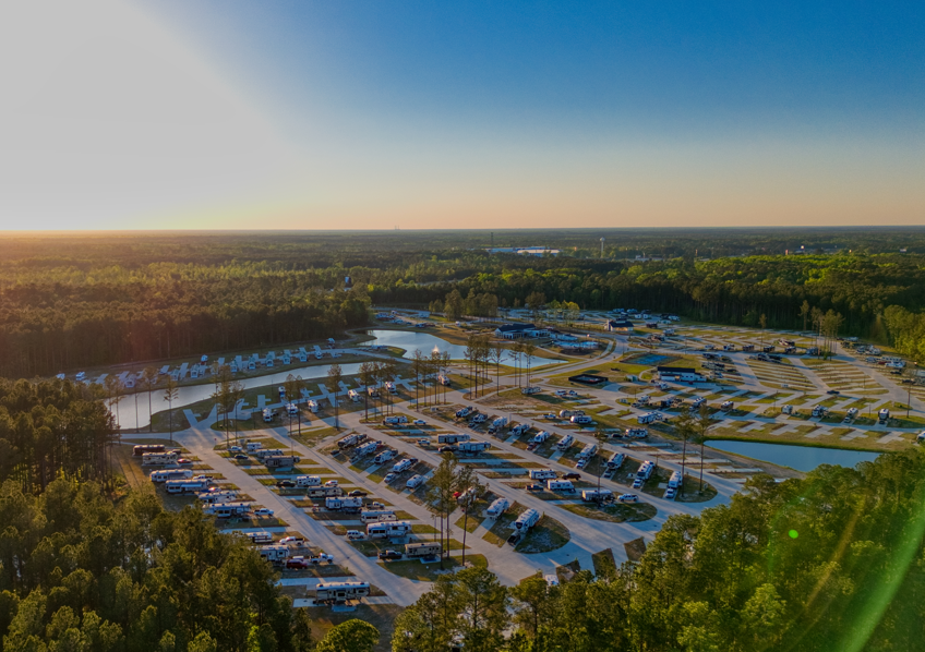 Aerial view of RV park with surrounding trees.