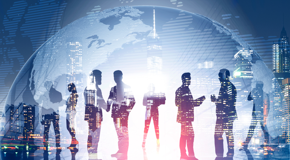 Silhouettes of businesspeople with city skyline.