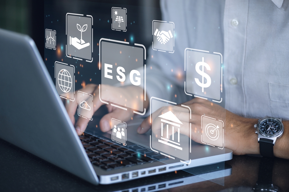 Person using laptop with ESG icons displayed